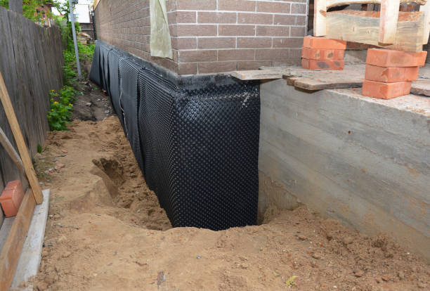 SJ Waterproofing Pros technician performing targeted Wet Basement Repair assessment in Tyner, IN